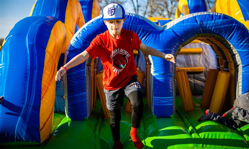 A boy exits an inflatable obstacle course